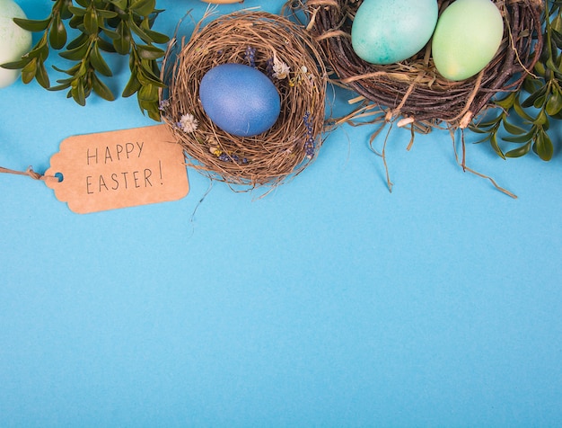 Colorful background with Easter eggs on blue background. Happy Easter concept.