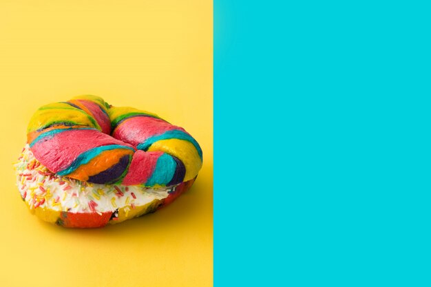 Colorful bagels on yellow and blue 