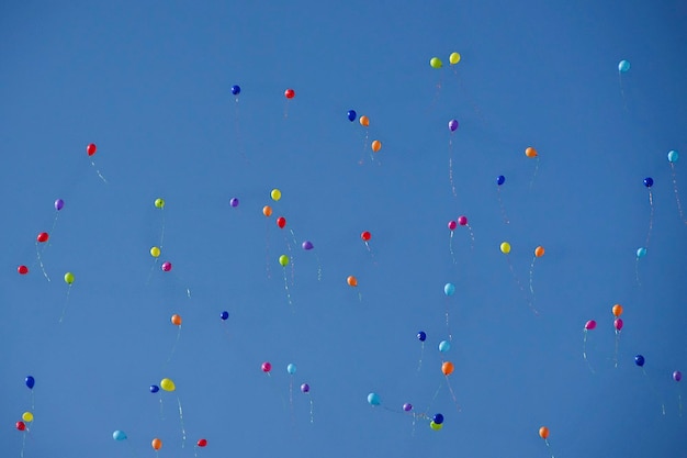 Colorful balloons against a blue sky