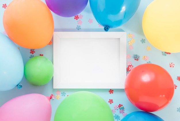 Colorful balloons around empty frame