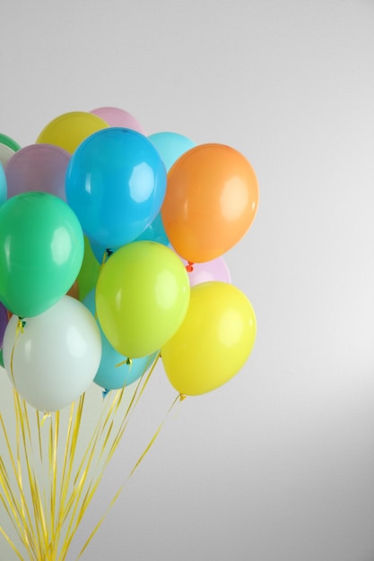 Colorful balloons on grey background