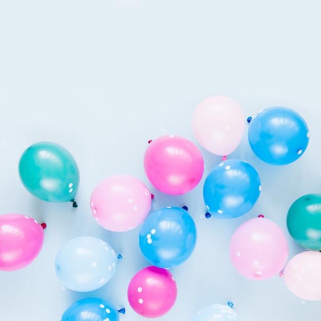 Colorful balloons on pastel blue  background. Festive or birthday party concept. Flat lay, top view.