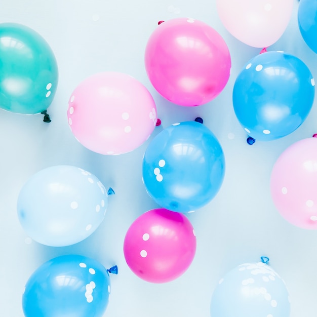 Colorful balloons on pastel blue  background. Festive or birthday party concept. Flat lay, top view.