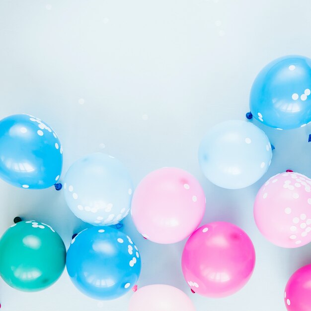 Colorful balloons on pastel blue  background. Festive or birthday party concept. Flat lay, top view.