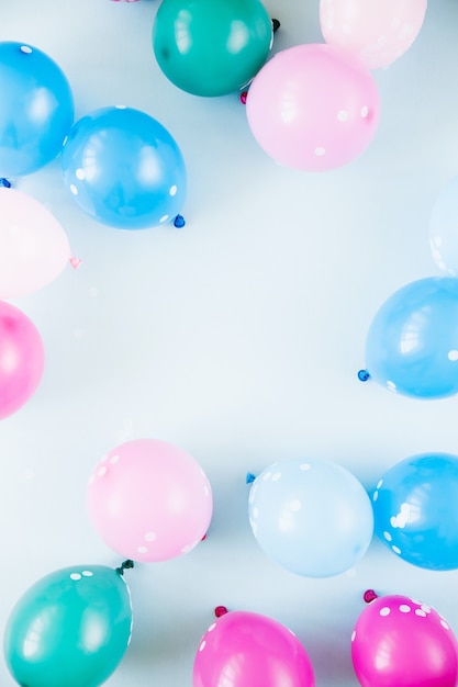 Colorful balloons on pastel blue  background. Festive or birthday party concept. Flat lay, top view.