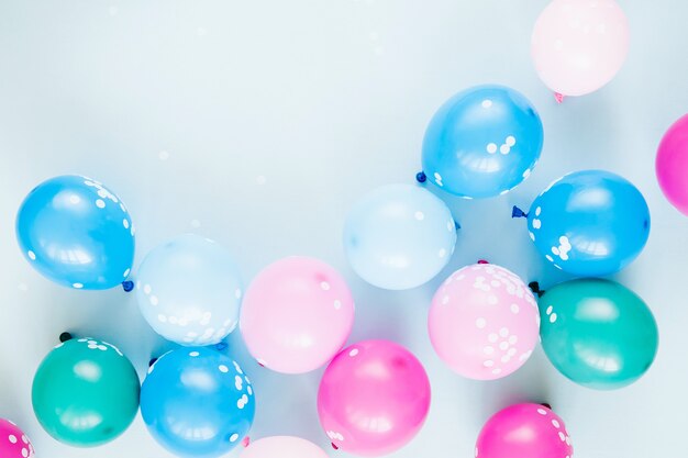 Colorful balloons on pastel blue  background. Festive or birthday party concept. Flat lay, top view.