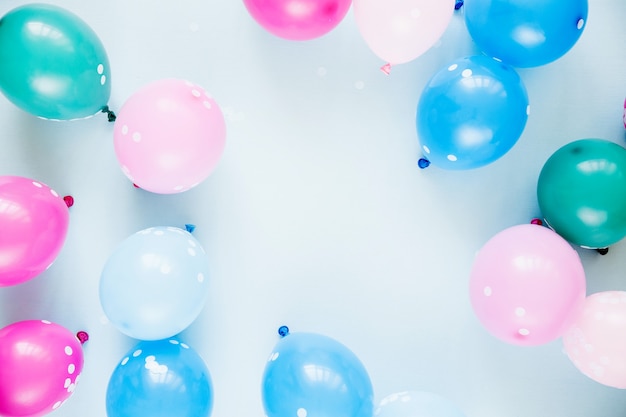 Colorful balloons on pastel blue  background. Festive or birthday party concept. Flat lay, top view.