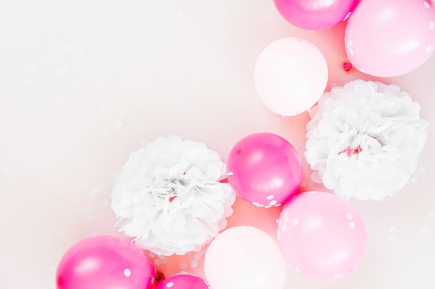 Colorful balloons on pastel color background. Festive or birthday party concept. Flat lay, top view.