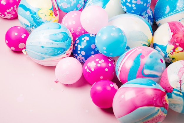 Colorful balloons on pastel color background. Festive or birthday party concept. Flat lay, top view.