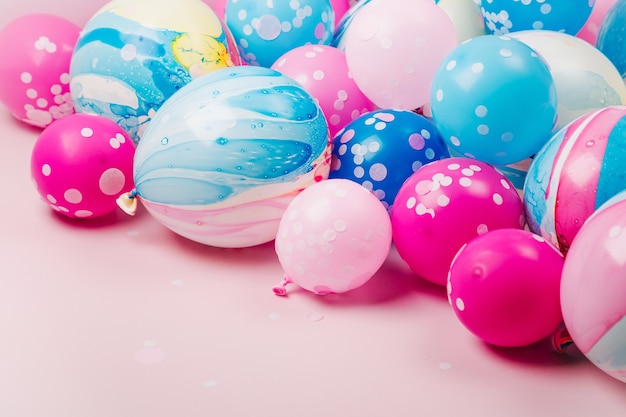 Colorful balloons on pastel color background. Festive or birthday party concept. Flat lay, top view.