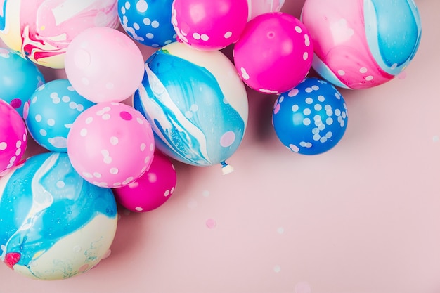 Colorful balloons on pastel color background. Festive or birthday party concept. Flat lay, top view.