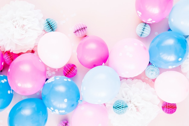 Colorful balloons on pastel color background. Festive or birthday party concept. Flat lay, top view.