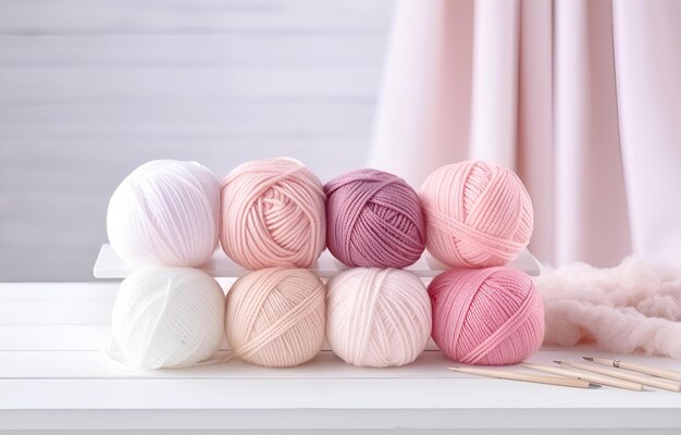 colorful balls of thread and metal knitting needles on a white w