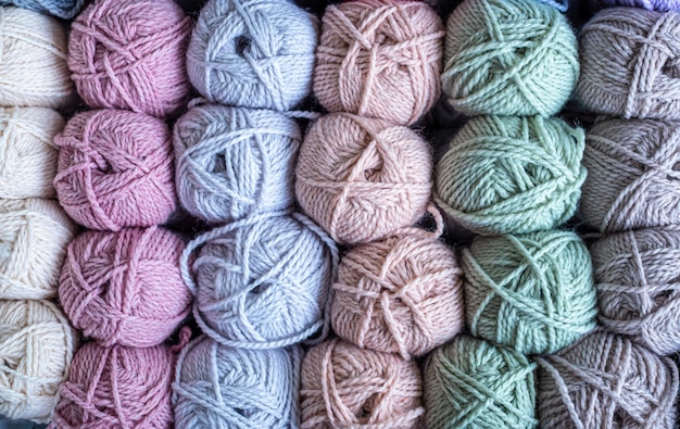 Colorful balls of wool on wooden table variety of yarn balls view from above