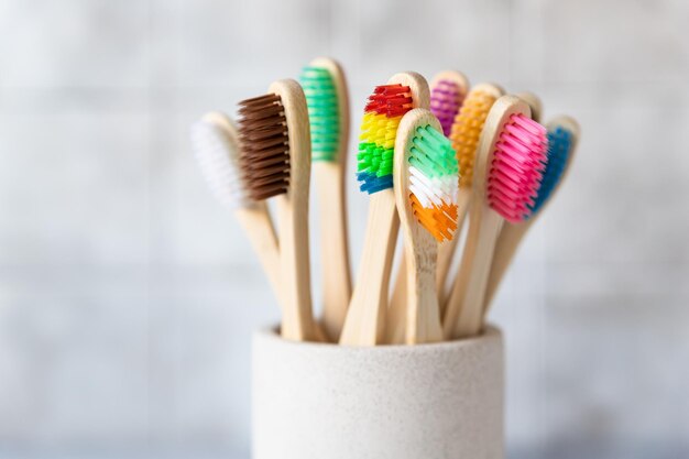 Colorful bamboo toothbrushes in cup Organic wooden brushes Zero waste plastic free eco friendly organic product concept