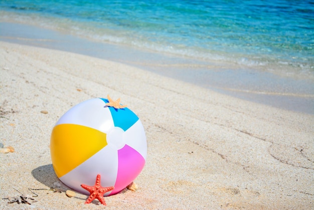 Colorful beach ball by a turquoise shore in sardinia