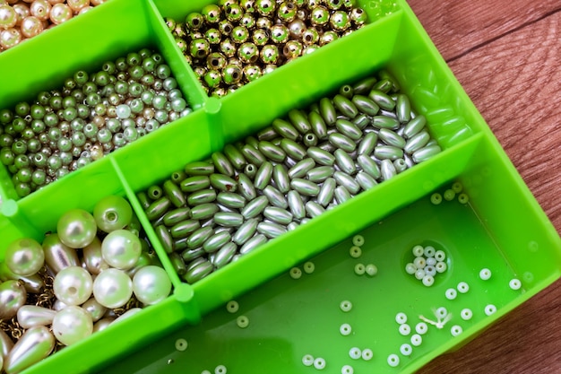 Colorful beads in containers close up handicrafts