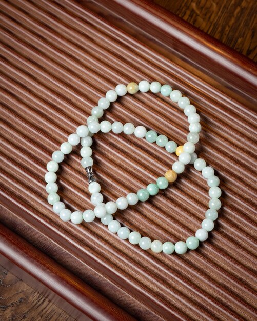Colorful beads made of natural semiprecious stones on a white background Isolated jewelry close up Stone texture energy mineral beaded necklaces rock