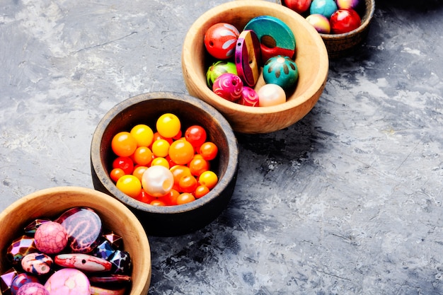 Colorful beads in wooden bowls