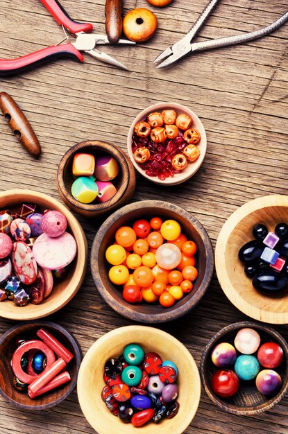 Colorful beads in wooden bowls