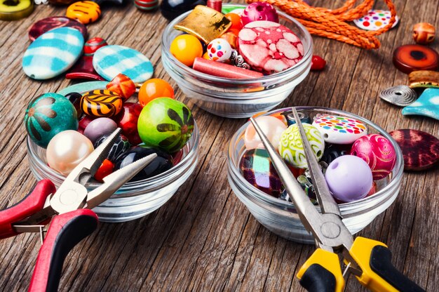 Colorful beads on a wooden surface