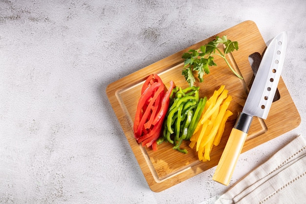 Colorful bell peppers sliced on cutting board