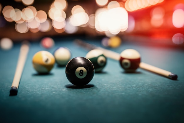 Colorful billiard balls on table close up