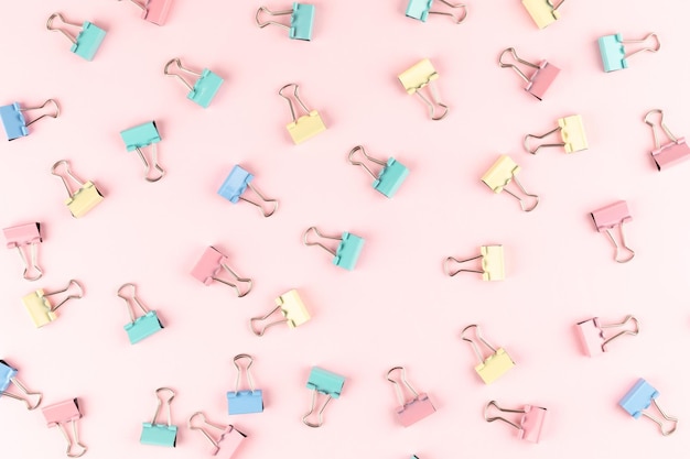 Colorful binder clip on pink background