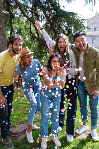 Colorful Birthday 5 Ethnically Diverse Friends Celebrating with Joyful Paper Streamers in City Park