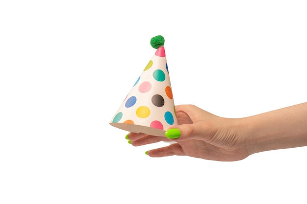 Colorful birthday cap in woman hands isolated on white background