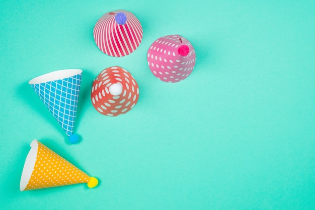 Colorful birthday caps on a blue background. Top view. Copy space.