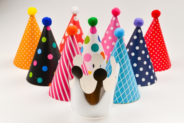 Colorful birthday caps on a white background.