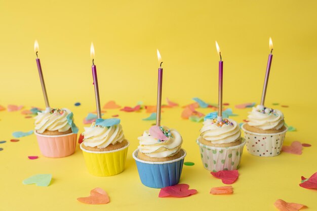 A colorful birthday cupcake with a colored candle