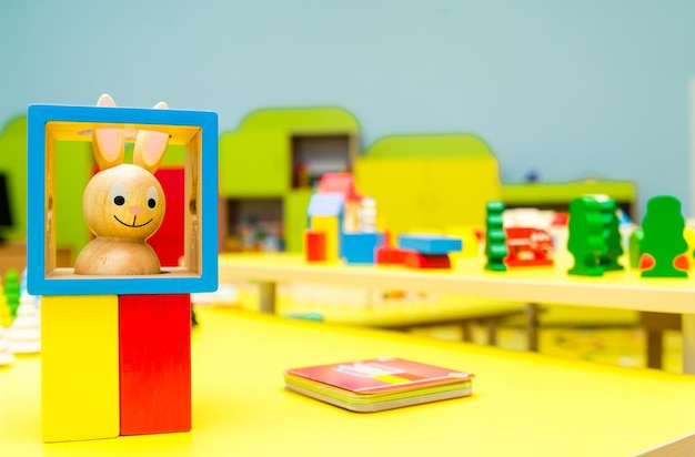 Colorful blocks for kindergarten on yellow table in game room