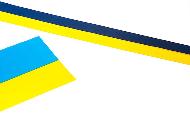 Colorful blueyellow fabric ribbon and flag of Ukraine isolated on white The symbol of the state Flat lay lay out Copy space Patriot's thing National pennant