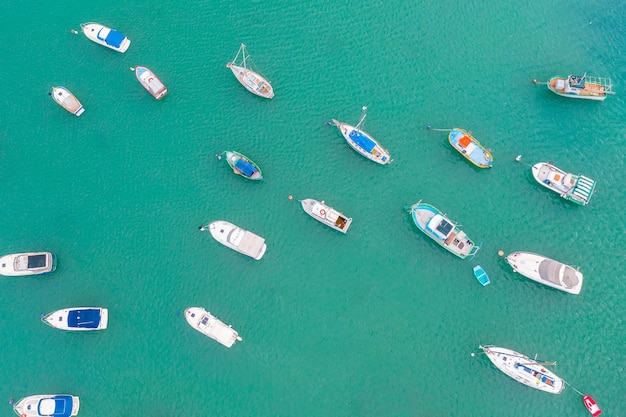 Colorful boats in the harbor of mediterranean fishing village aerial view