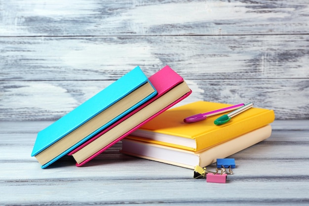 Colorful books on wooden background
