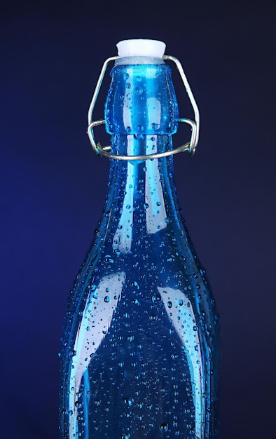 Photo colorful bottle on dark blue background