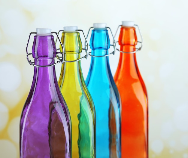 Colorful bottles on light background