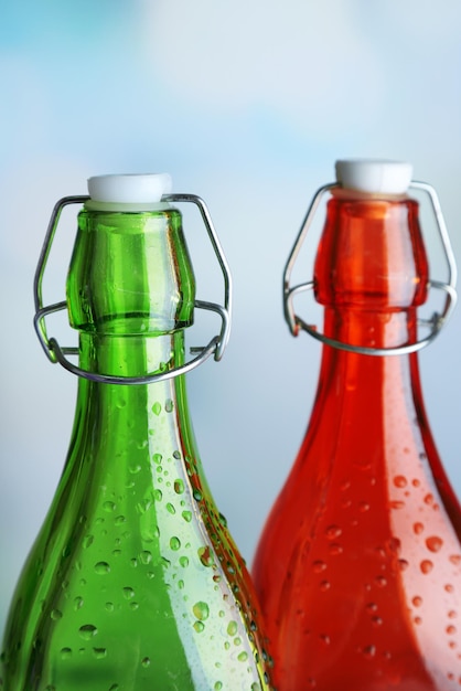 Colorful bottles on light background