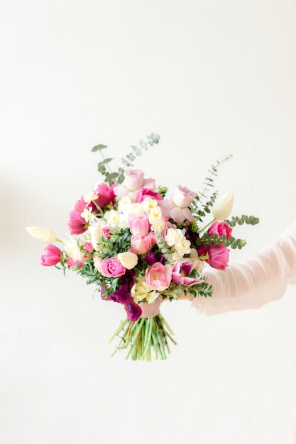 Colorful bouquet of flowers in hand