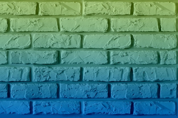 Photo a colorful brick wall with a blue and green background.