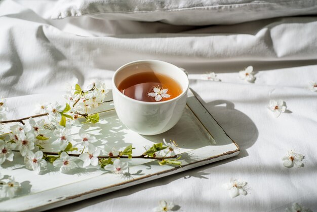 Colorful bright floral pattern with tea cup. Flat lay.