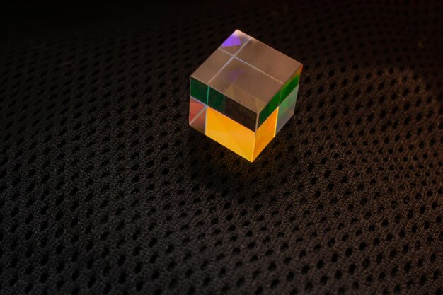 Photo colorful bright glass prism cube refracting light in vivid rainbow colors