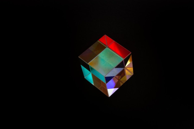 colorful bright glass prism cube refracting light in vivid rainbow colors