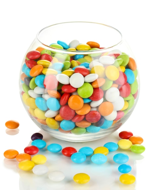 Colorful candies in glass bowl isolated on white