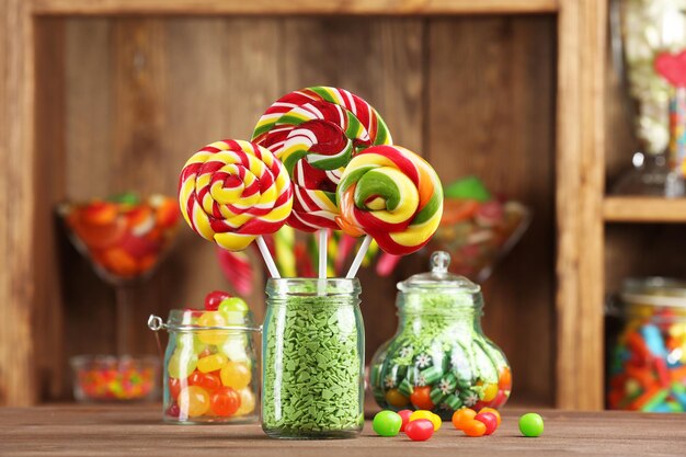 Colorful candies in jars on table in shop