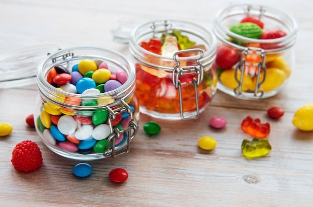 Colorful candies, jelly and marmalade in jars on the table