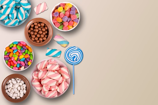 colorful candies marshmellows chocolate balls in jars lollipops and sweet peanuts and copy space