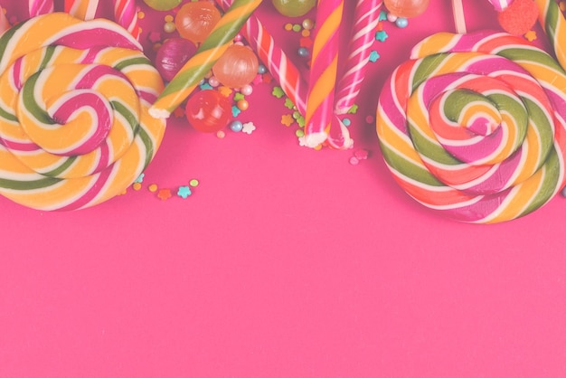 Colorful candies on a red background Lollipop Top view Copy space